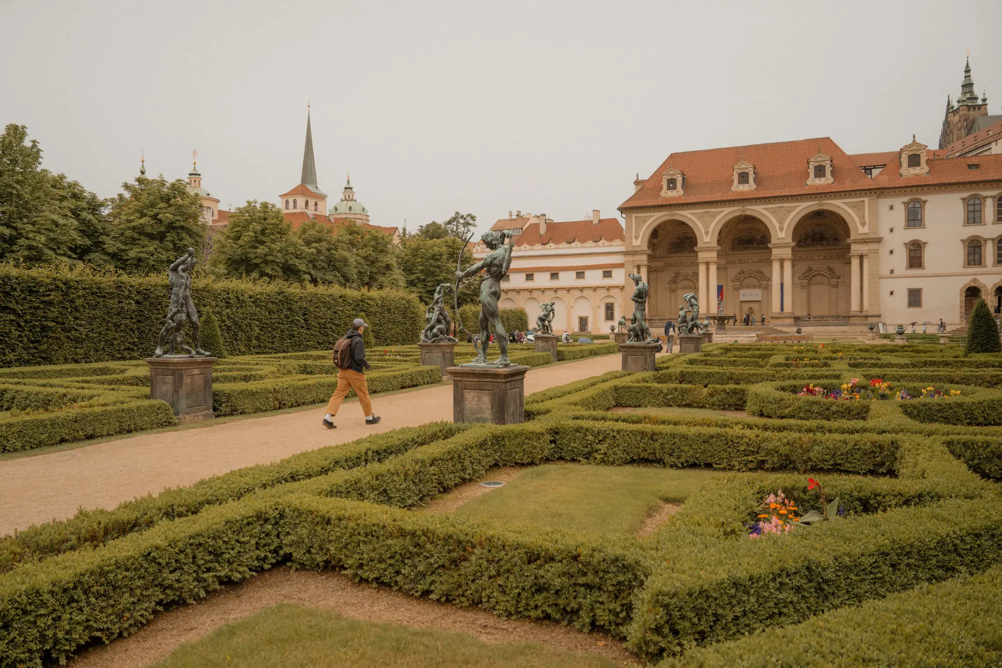 Baroque statues and clipped hedges in the Wallenstein Garden, Prague Castle beyond