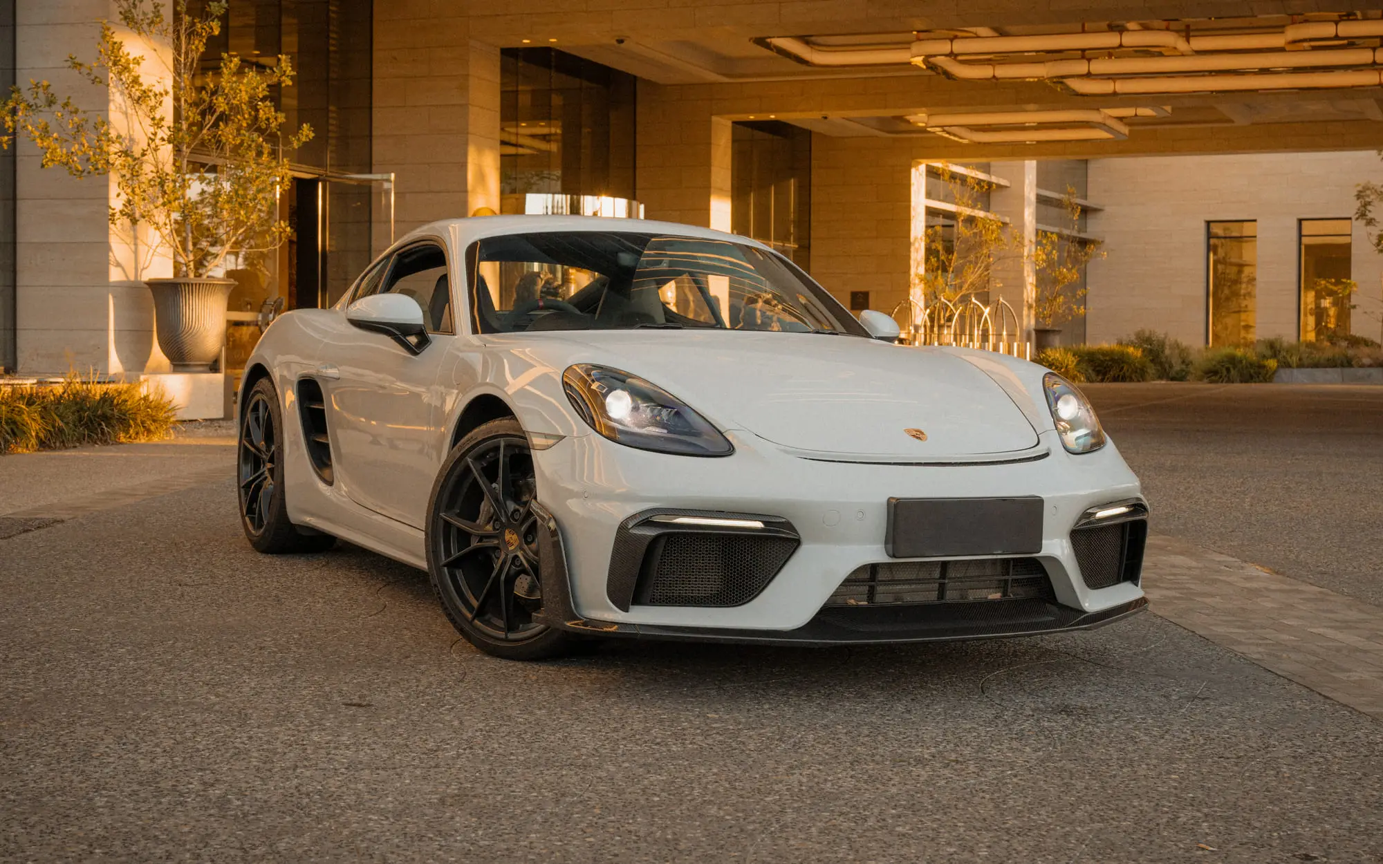 The 718 outside a lit hotel portico at golden hour