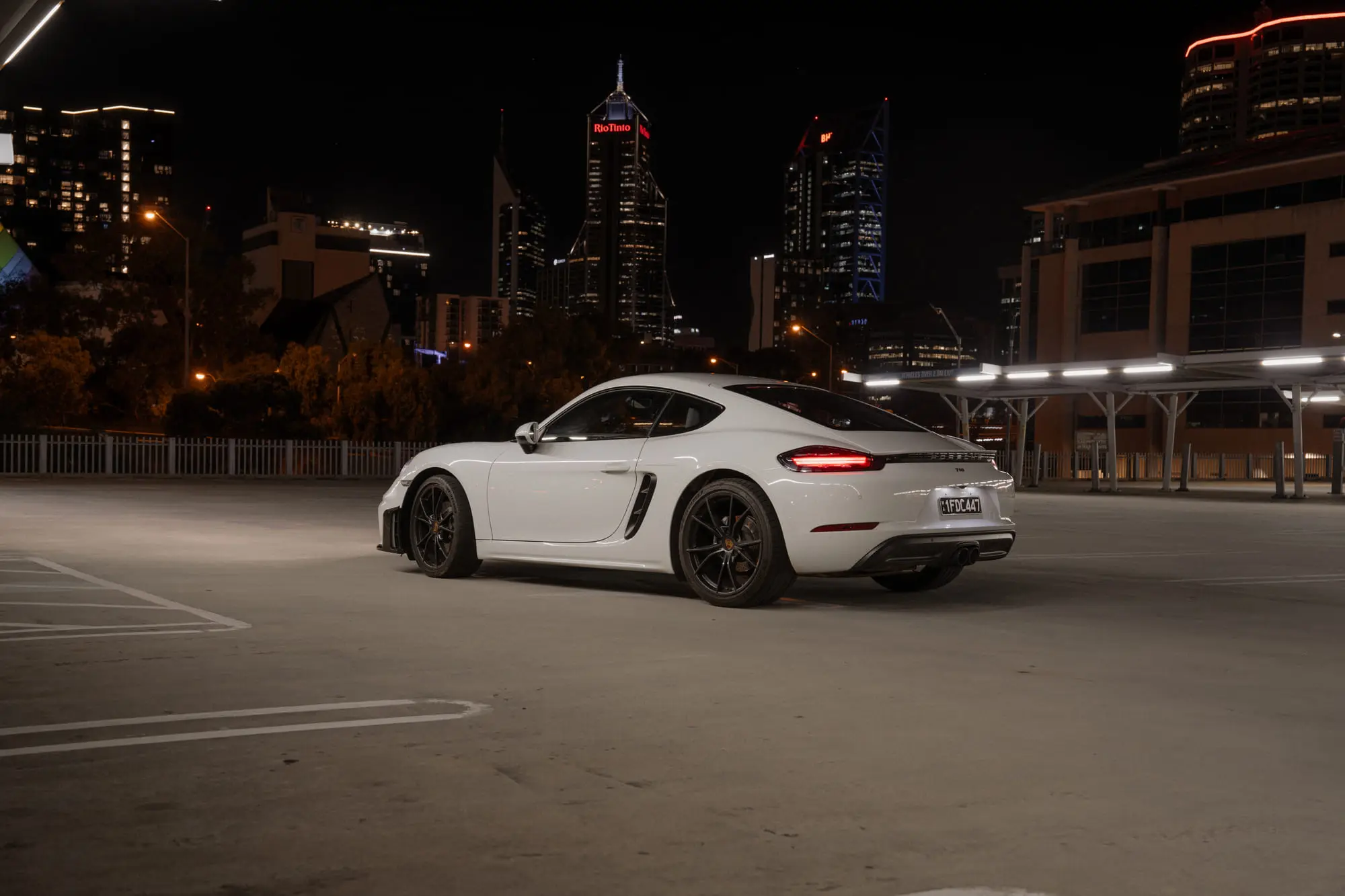 The 718 on a rooftop against the Perth skyline at night