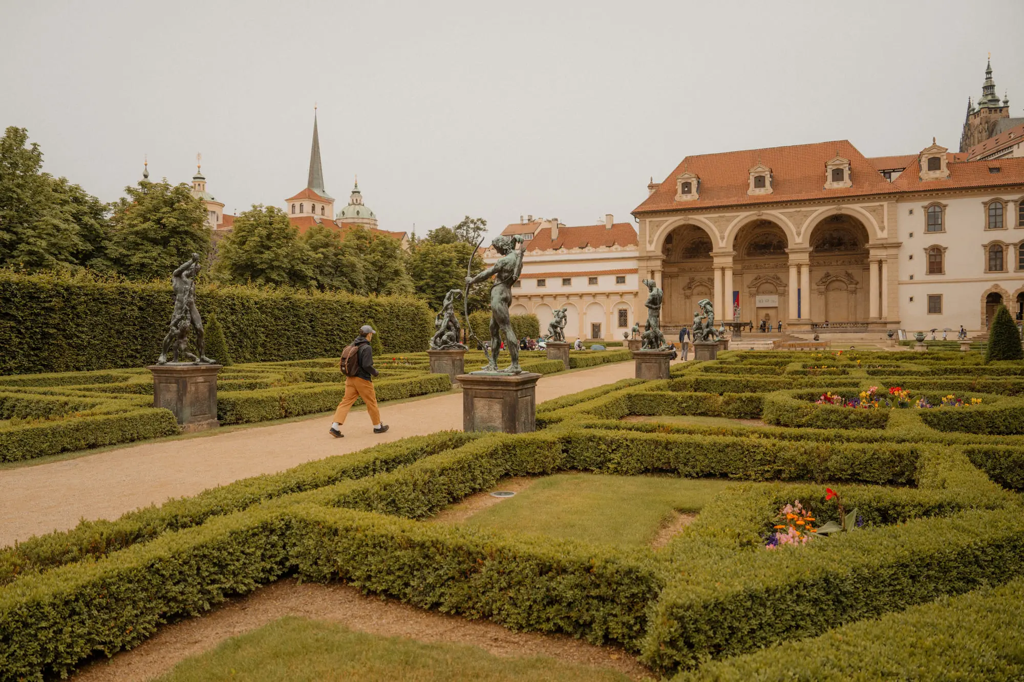 Baroque statues and clipped hedges in the Wallenstein Garden, Prague Castle beyond