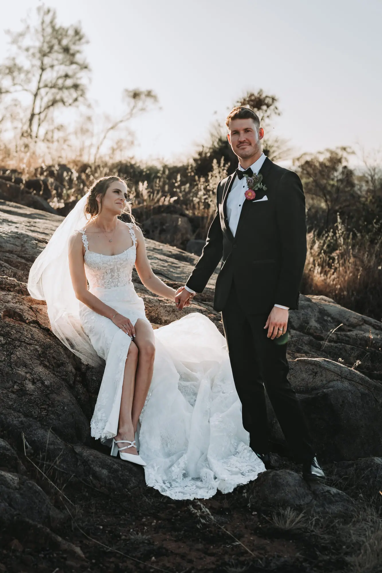 A couple on granite rocks in the bush at golden hour