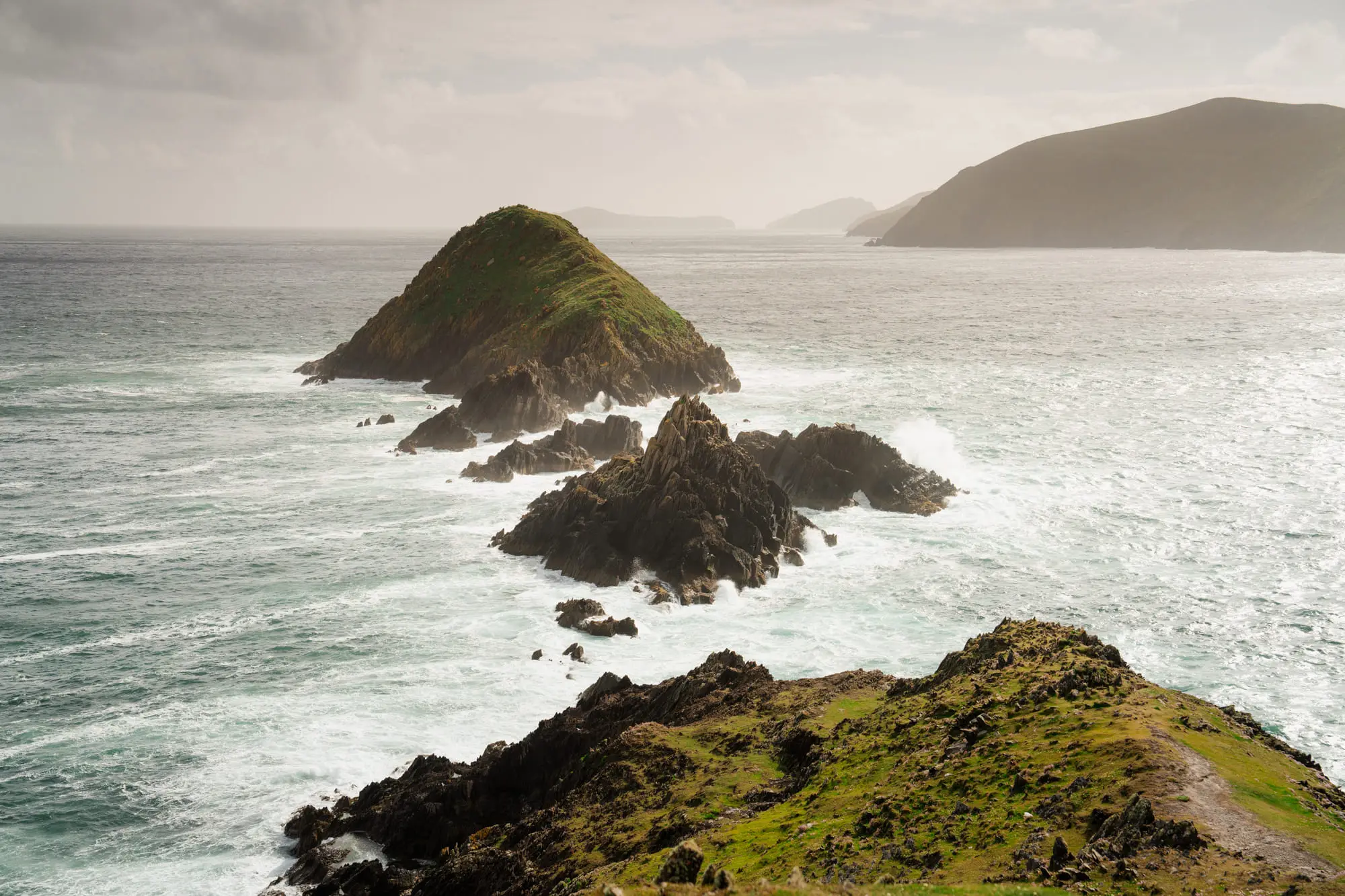 Sea stacks off Dunmore Head in heavy, shifting light