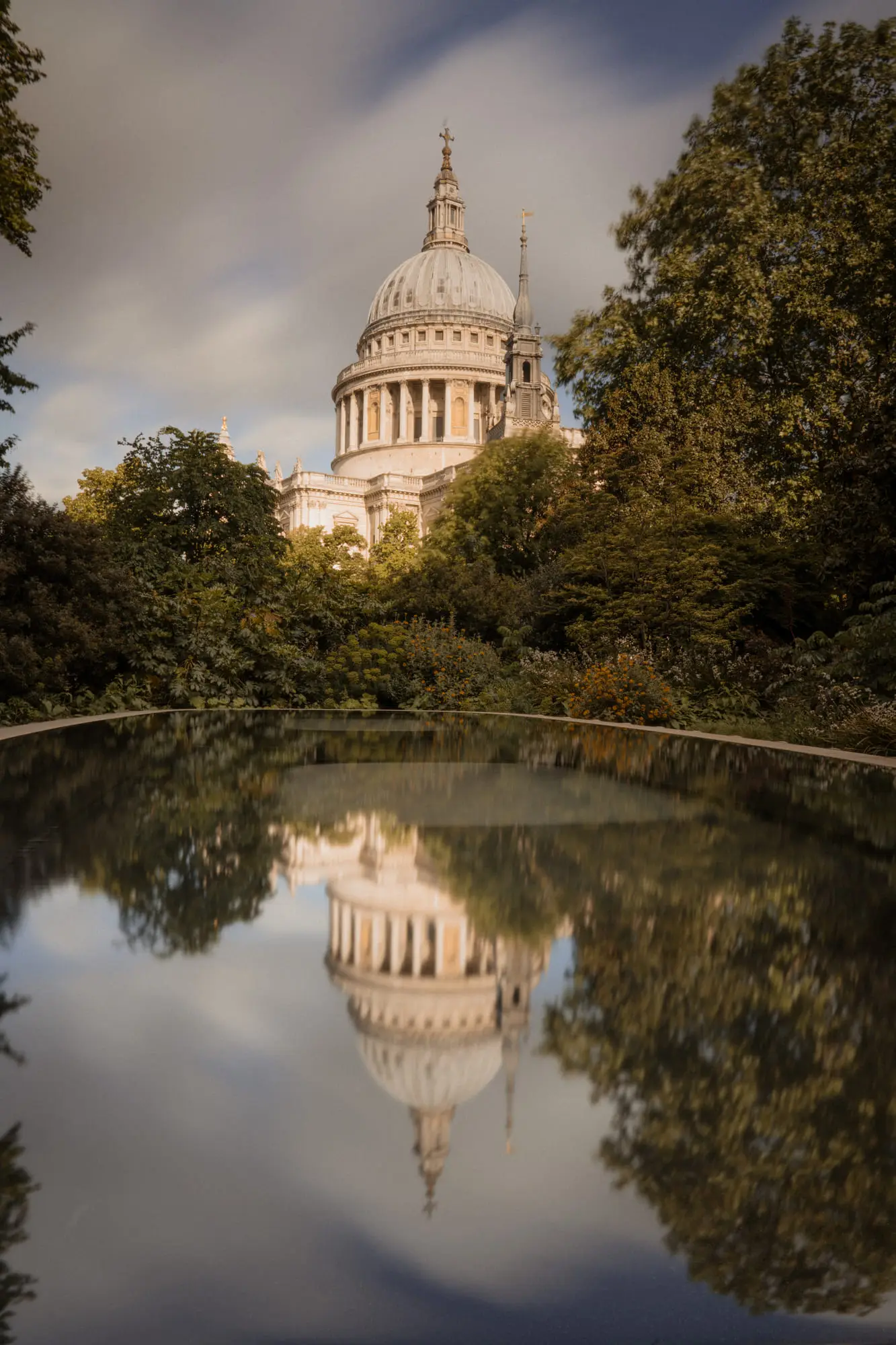 St Paul's Cathedral mirrored in a still garden pool