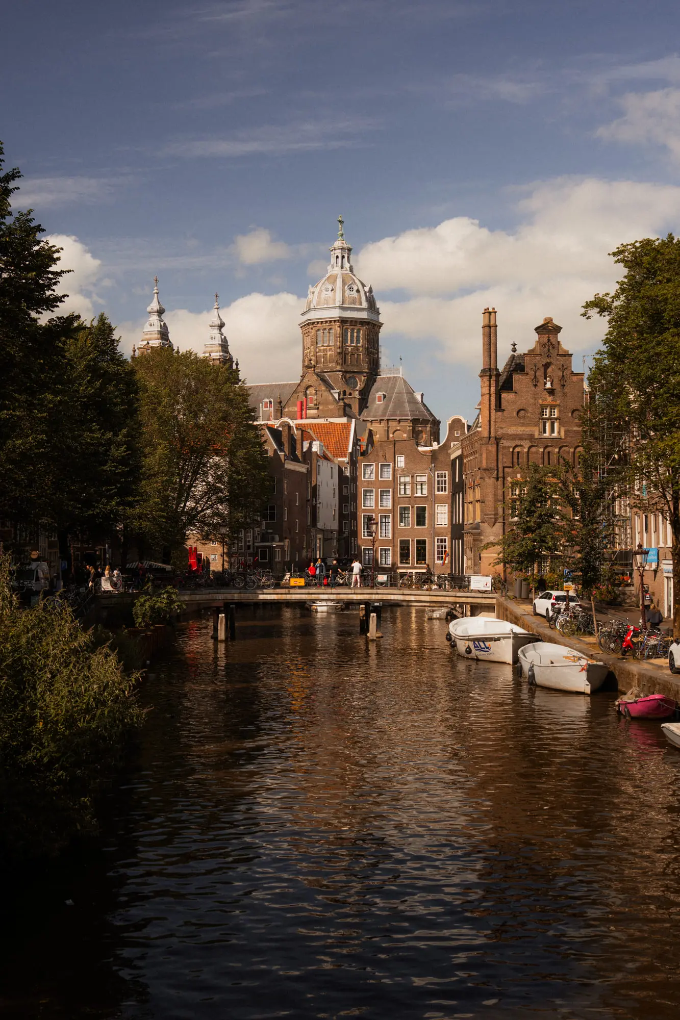 St Nicholas Basilica beyond a canal on a bright blue day