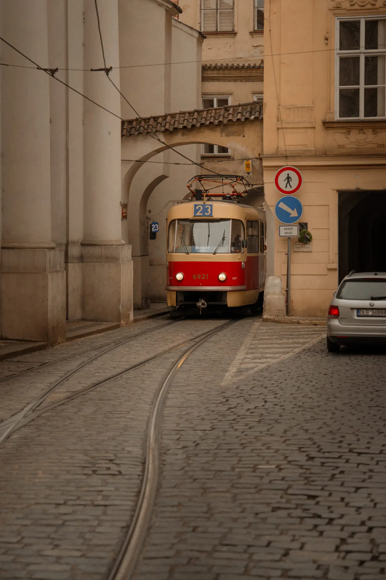 The number 23 tram on a cobbled Mala Strana street