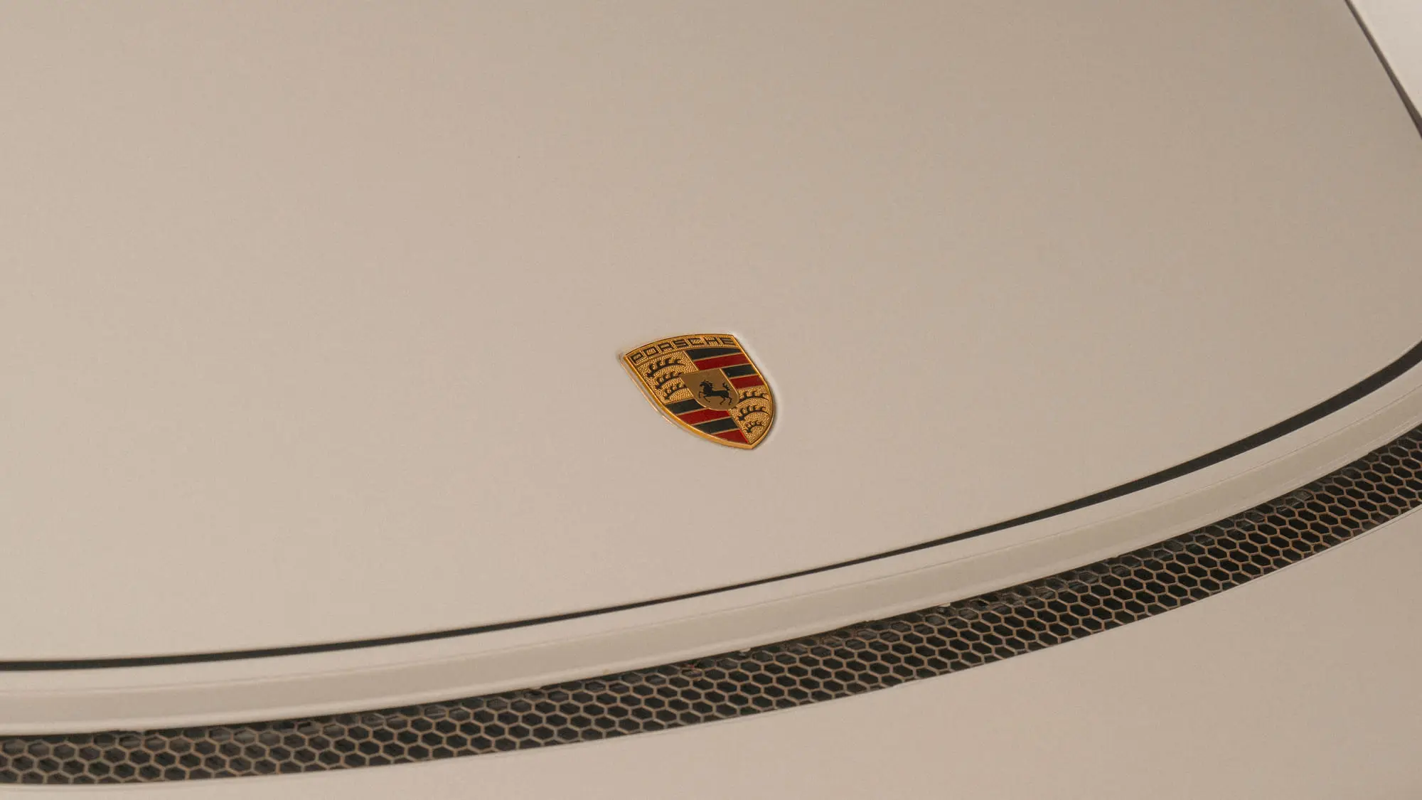 The Porsche crest and bonnet vent, close