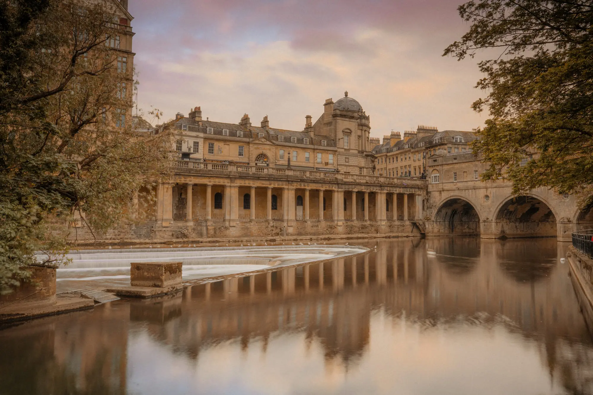 Pulteney Bridge and the weir at dusk, mirrored in the Avon