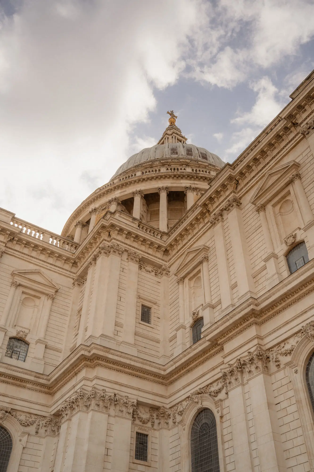 The dome and stonework of St Paul's from below, warm light