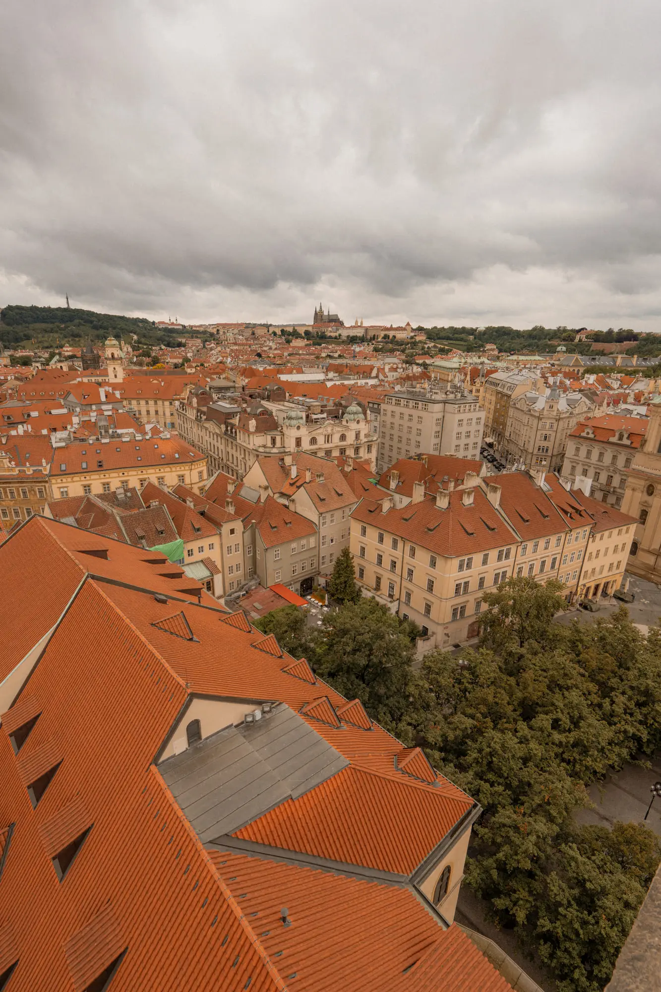 Prague's red rooftops and the castle on the skyline, from a tower
