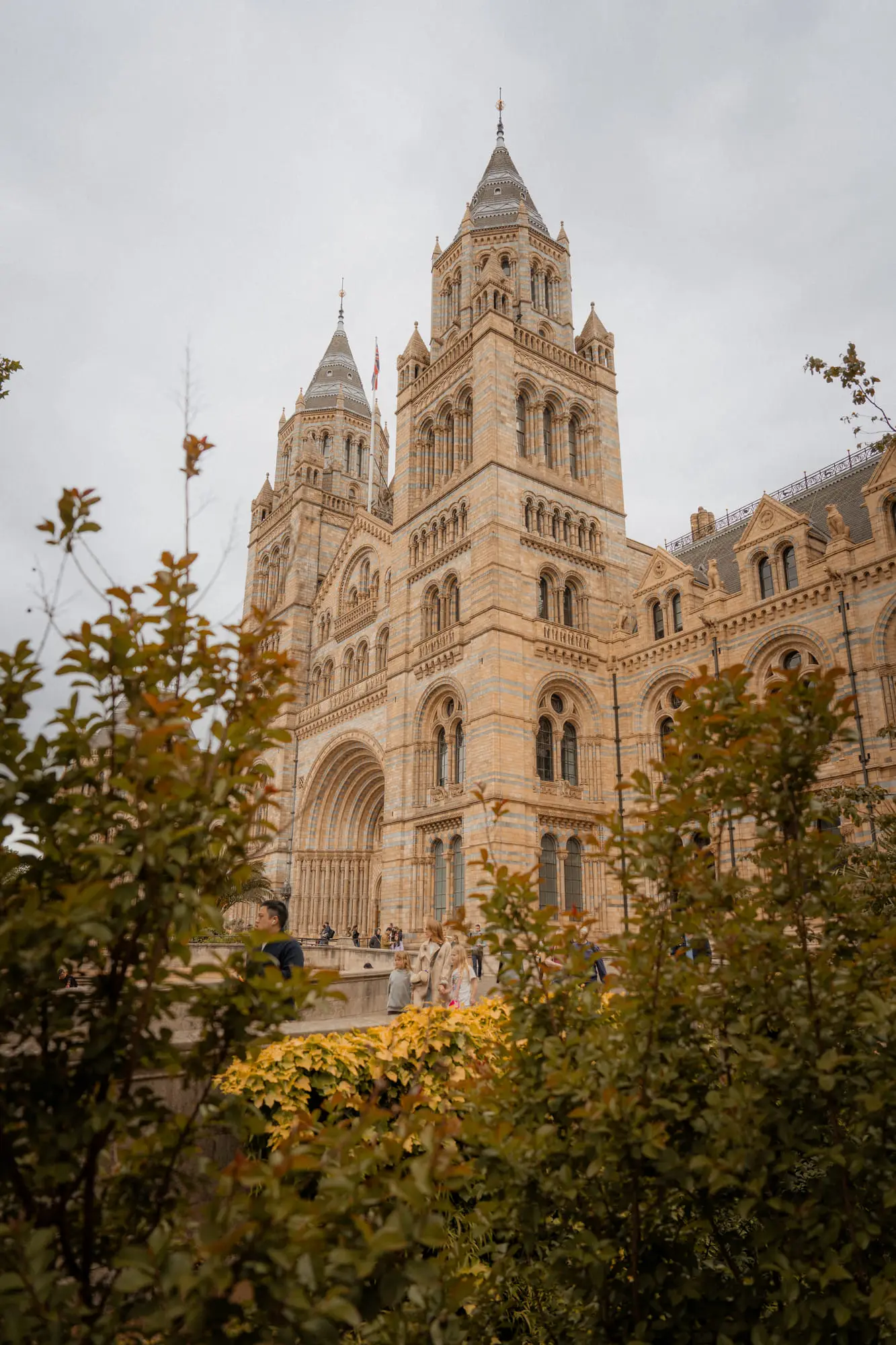 The towers of the Natural History Museum through autumn foliage