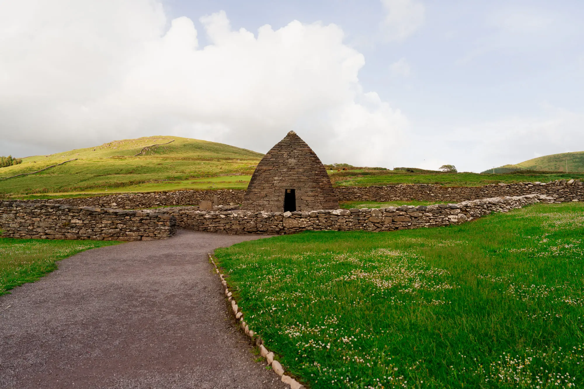 The dry-stone Gallarus Oratory in a green Dingle field